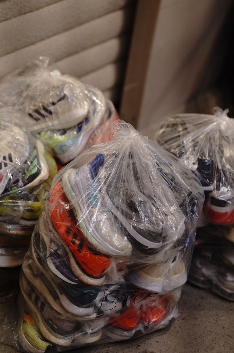 Bags of donated running shoes